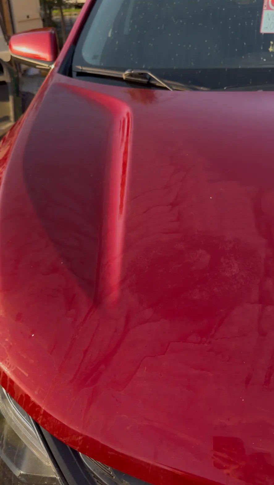 Red Chevy Equinox hood - before